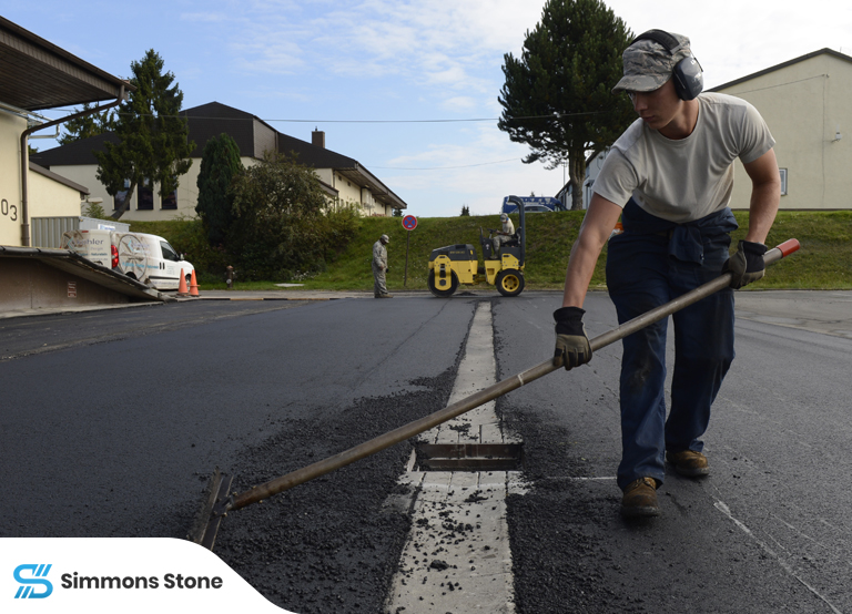 Crew performing maintenance on asphalt paving