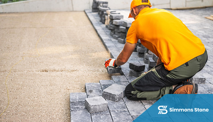 Worker paving a commercial property with precision