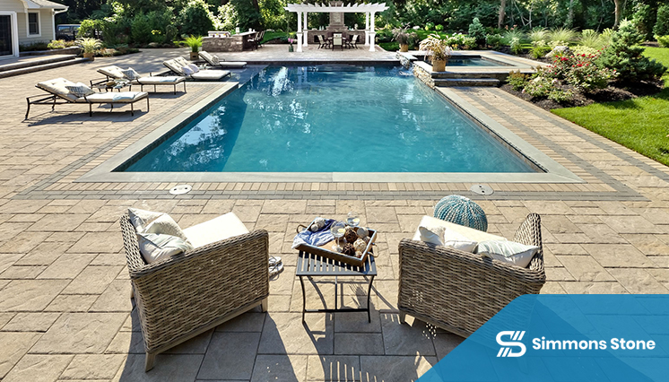 Poolside area with paver patio, pergola, seating, and kids’ pool