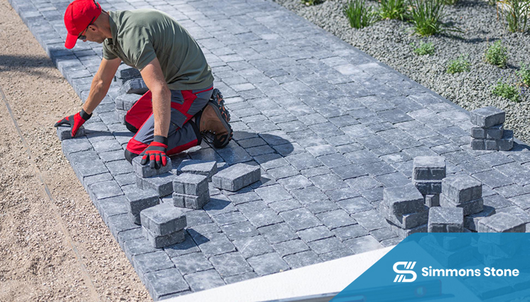 Professional contractor installing a paver driveway