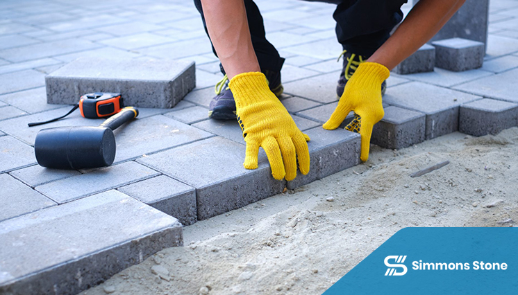 Technician performing routine maintenance on outdoor pavers