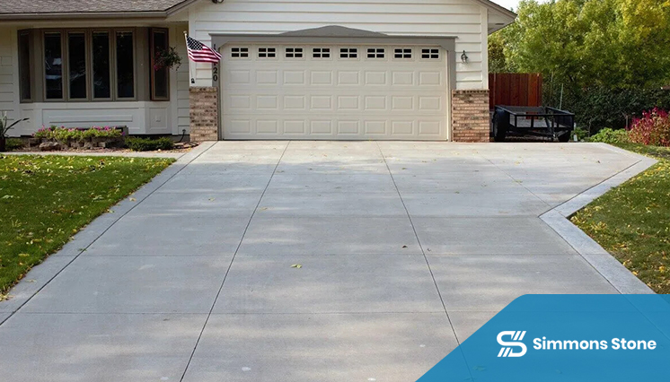 Residential concrete driveway leading to garage