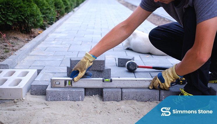Professional lifting and leveling of pavers in repair process