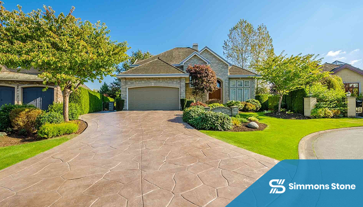 Curved stamped concrete walkway through landscaped garden