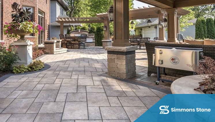 Backyard paver patio with outdoor kitchen and dining area