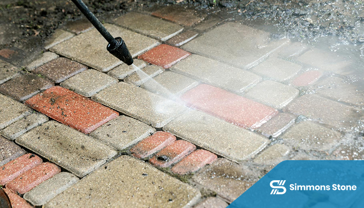 Pavers being cleaned using surface cleaner and pressure wash