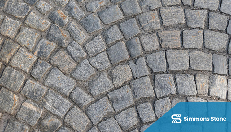 Close-up of installed stone pavers in a backyard