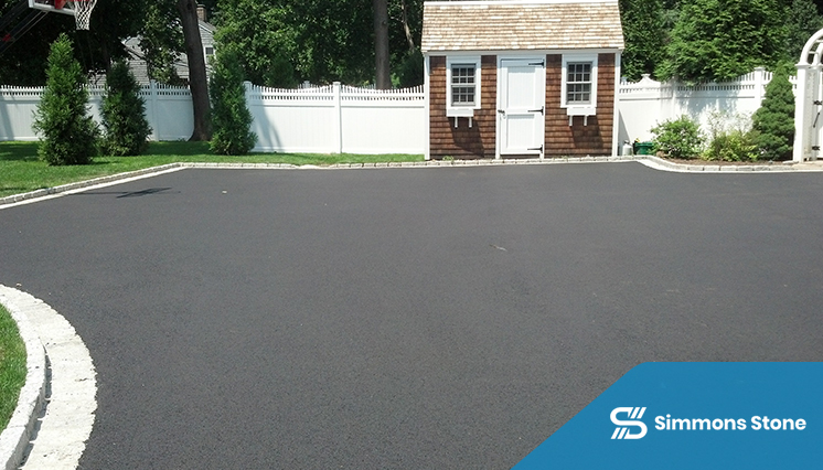 Fresh asphalt driveway being sealcoated