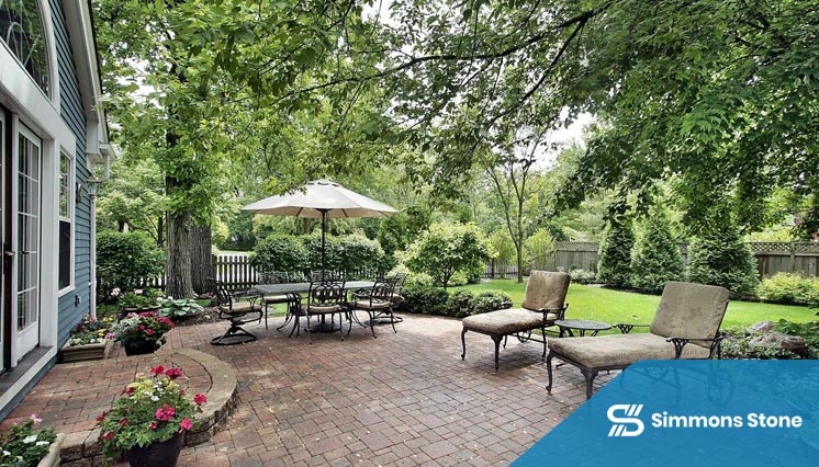 Brick patio designed as an outdoor dining area with shade structure