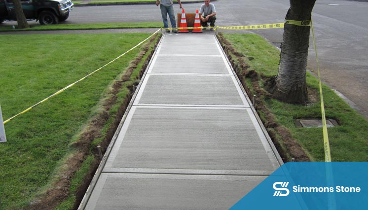 Freshly installed concrete sidewalk along residential street