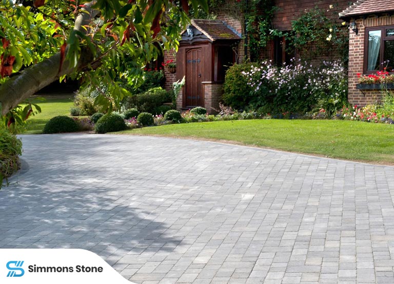 Common paver problems - Cracked and uneven surfaces in a residential driveway