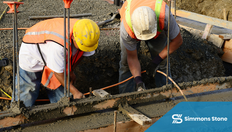 Worker preparing site for concrete curb installation