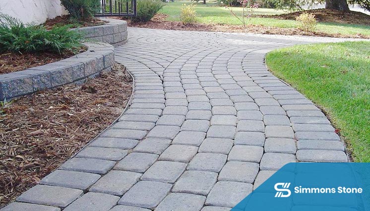 Natural stone walkway leading to a home's front entrance with clean edging