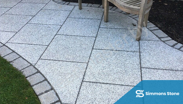 Granite stone patio with seating area in backyard