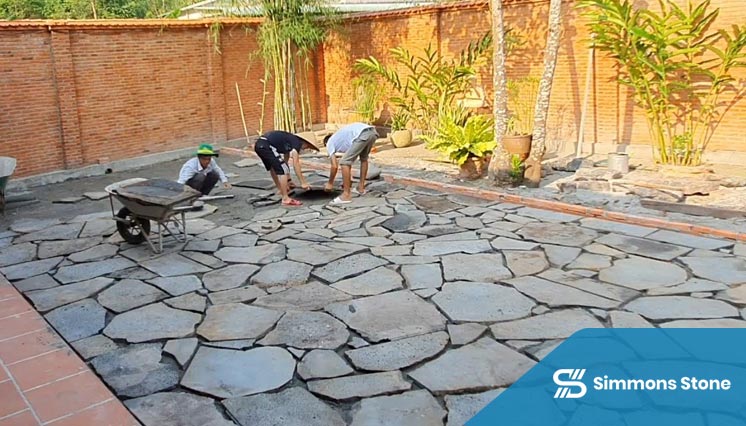  Installation team laying natural stone pavers with precision