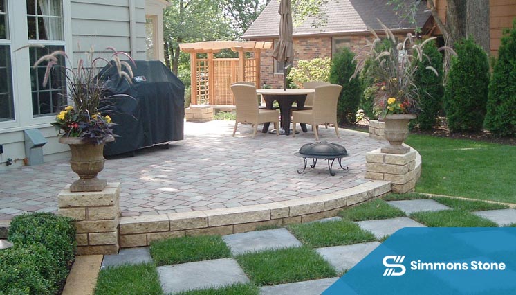 Brick paver patio nestled in a landscaped garden with greenery