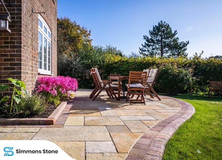Durable patio pavers in a backyard with simple landscaping