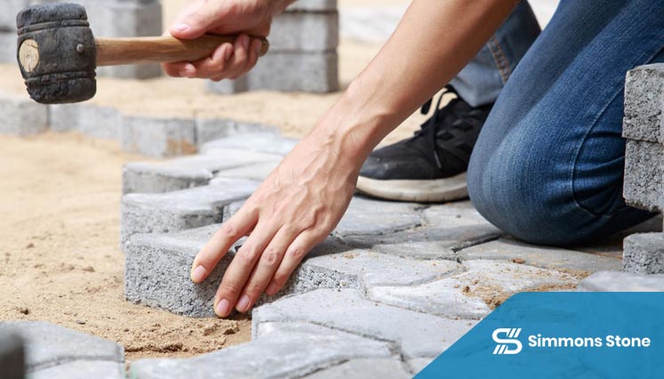 Crew installing a paving stone driveway 