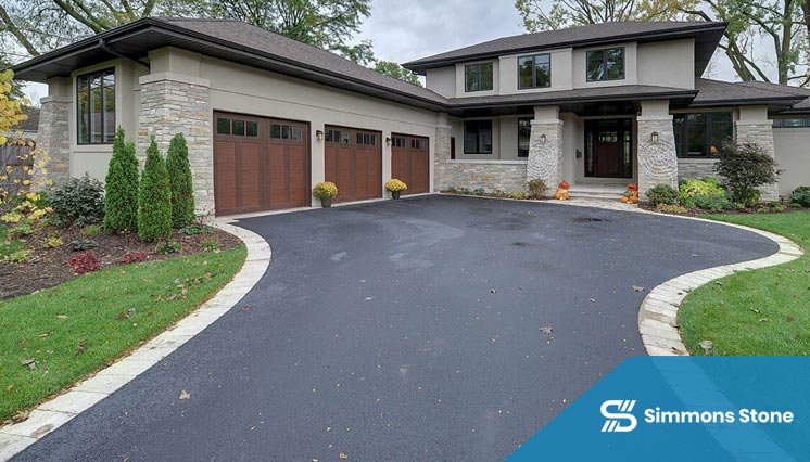 Curved asphalt paving driveway through a landscaped garden