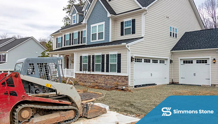 Concrete driveway being demolished with heavy equipment