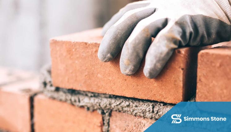 Bricklayer installing boundary wall in Pasadena
