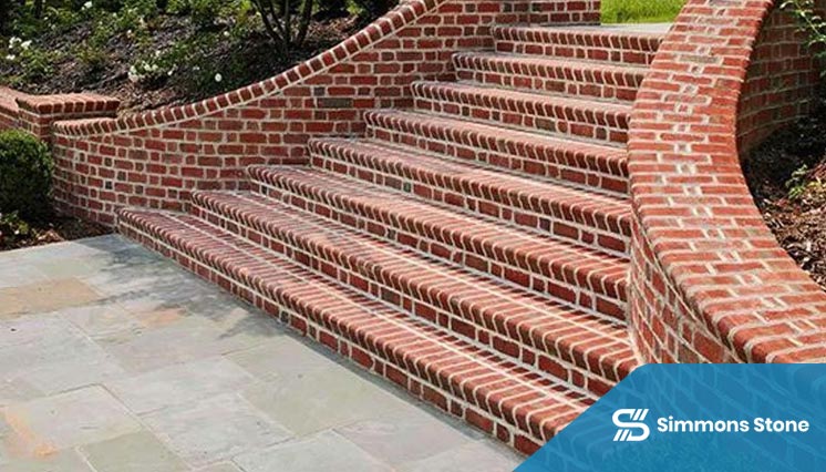 Custom brick stairs connecting patio and garden