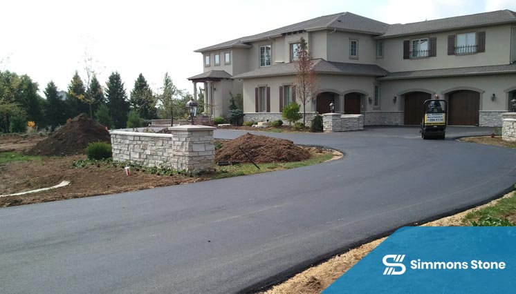 Sealcoating applied to asphalt driveway